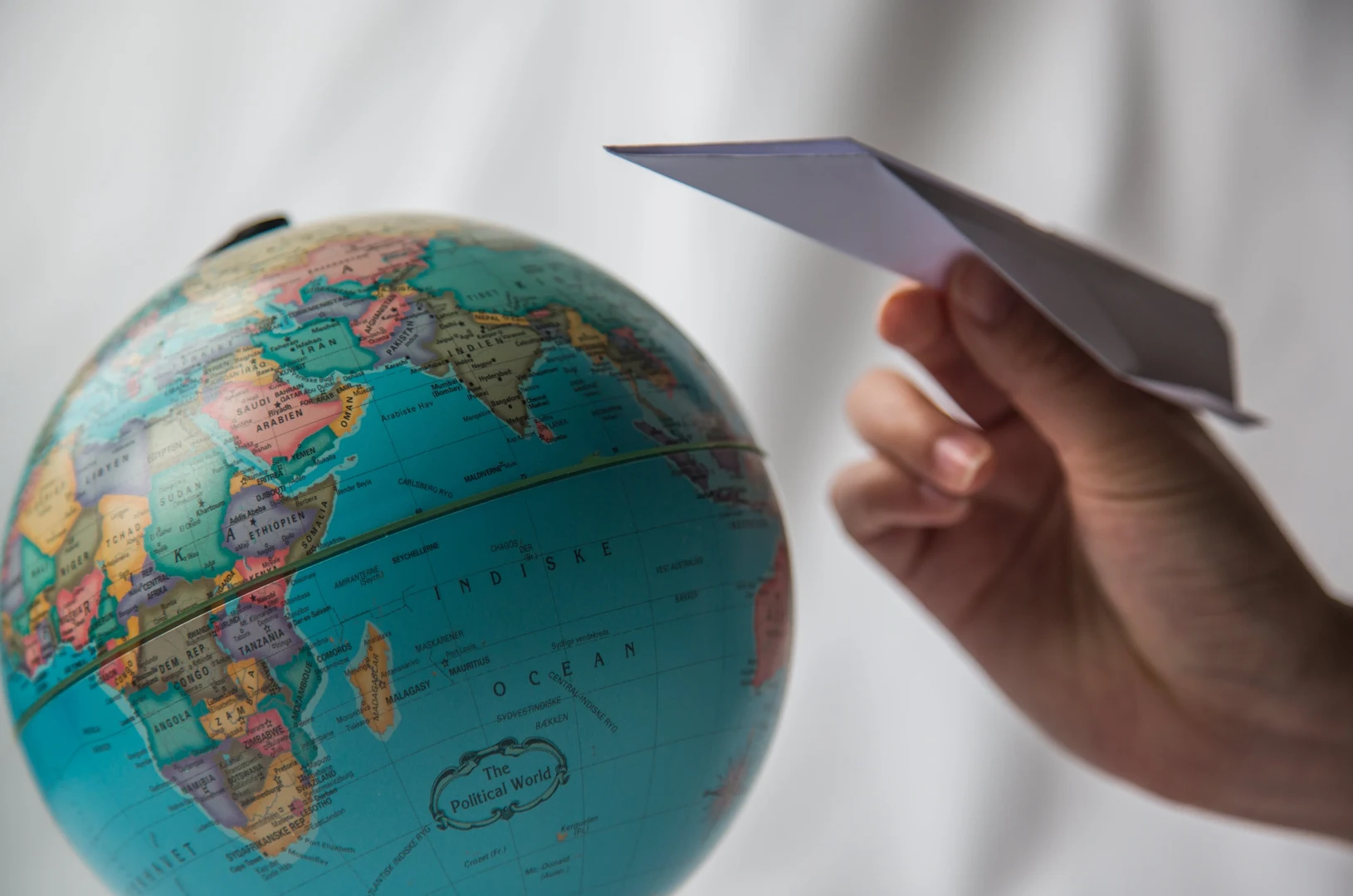 Eine Wissenschaftlerin und ein Wissenschaftler arbeiten hinter einer Glasfassade und mischen Chemikalien mit Großgeräten.