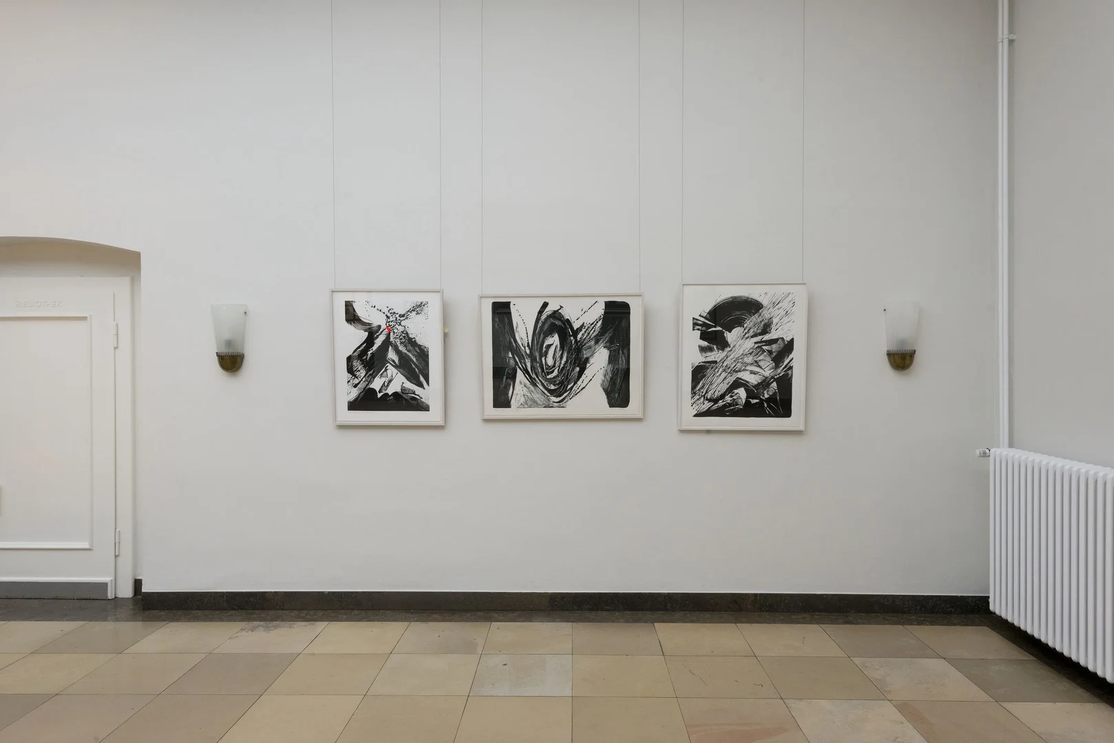 Eine Wissenschaftlerin und ein Wissenschaftler arbeiten hinter einer Glasfassade und mischen Chemikalien mit Großgeräten.